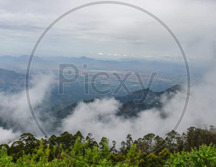 Mountain Covered With Green Forest And Low Cloud