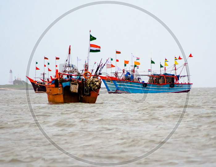 ferry boats sail on the sea from okha to dwarkadhish temple Gujarat India