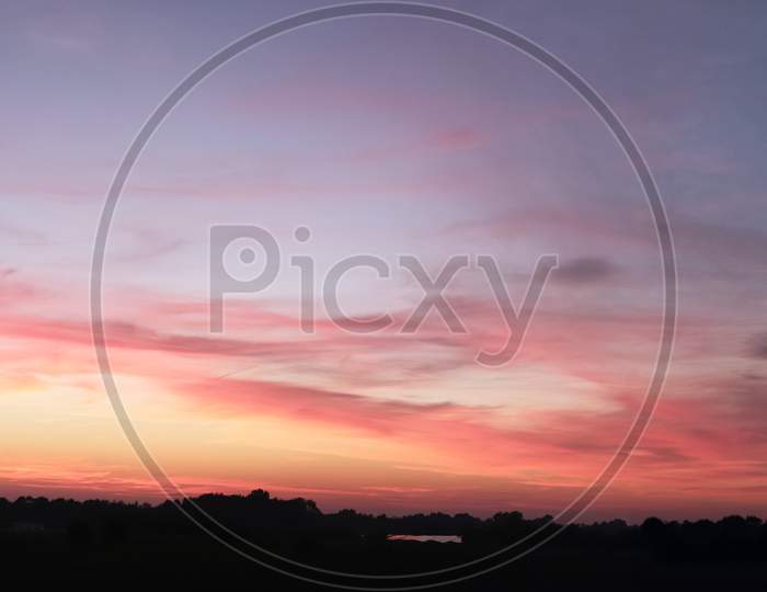 Beautiful panorama of orange and yellow cloudscapes at sunrise sunset  on a blue sky in high resolution