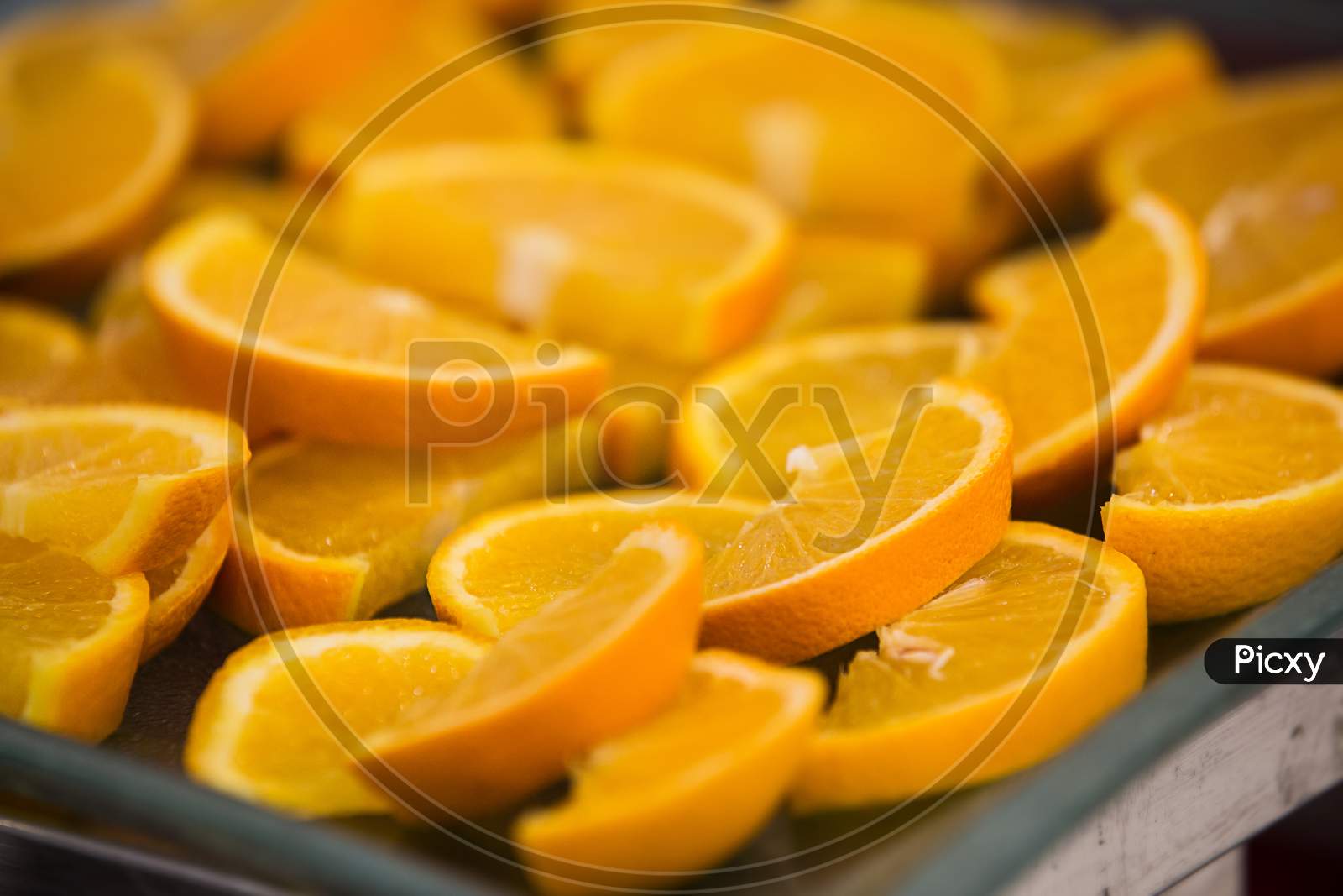 Lots Of Sliced Yellow Oranges In A Tray
