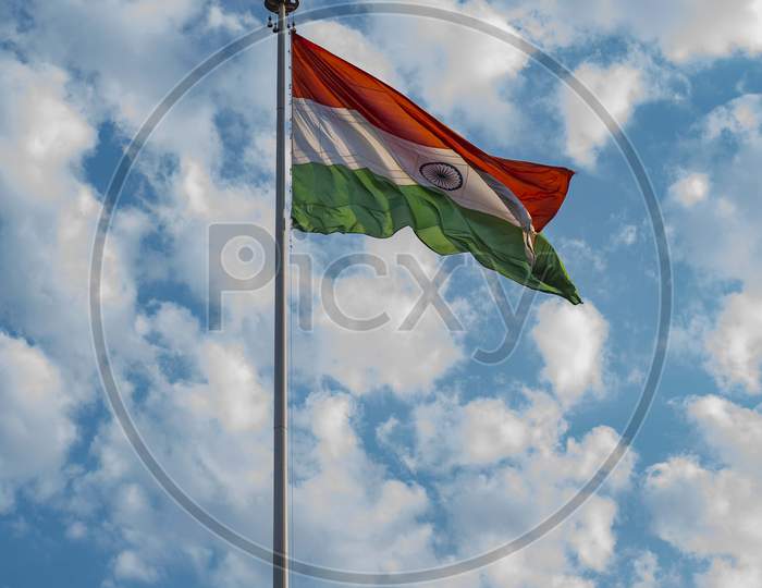 Indian National Flag Hoisted In The Blue Cloudy Sky On 74Th Indian Independence Day