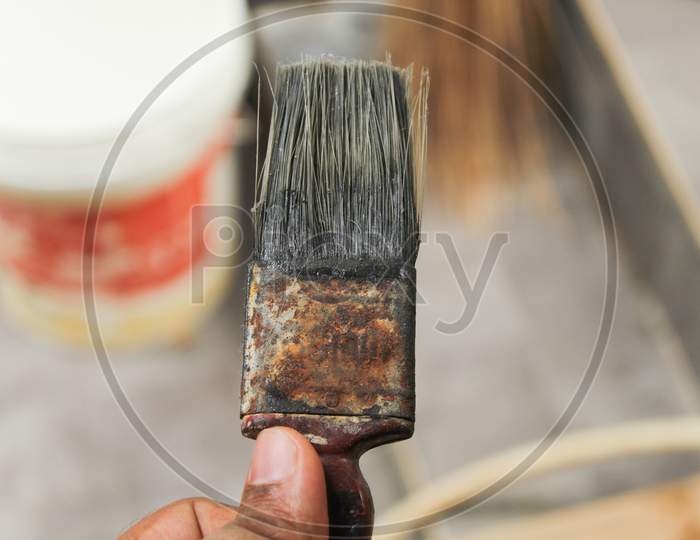 A Paint Brush Held In Hand