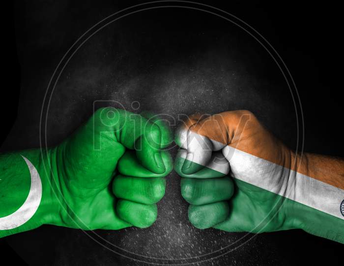 Conflict Between India And Pakistan, Male Fists With Flags Painted On Skin Isolated On Black Background - Governments Conflict Concept