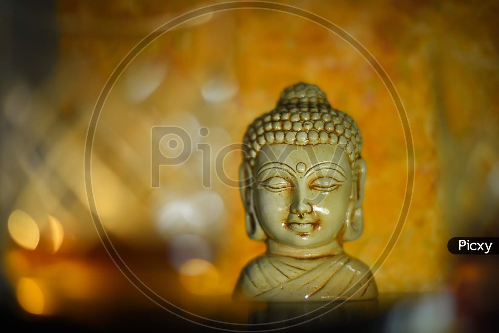 Golden Buddha statue close up .Siddhartha bronze statue. Close up of Buddha beautiful serene face with closed eyes. Best meditation inspiration image or mindfulness background.Copy space.