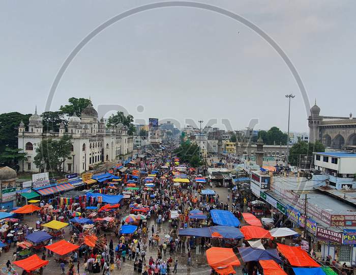 Wide image of busy market near Charminar, Hyderabad.