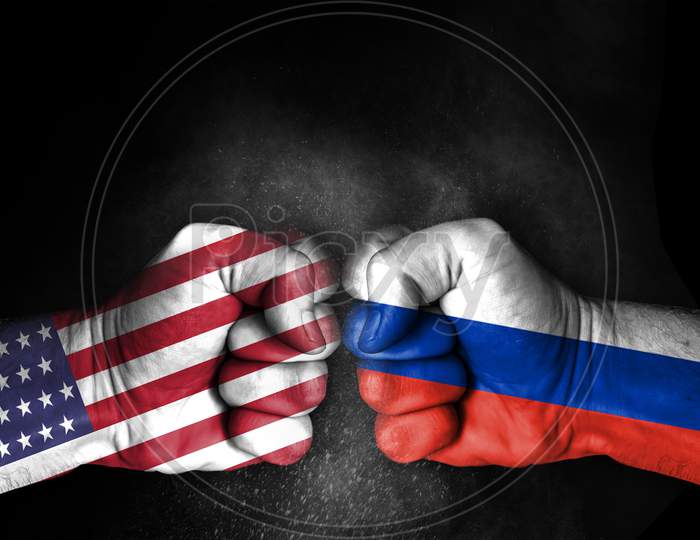 Conflict Between Usa And Russia, Male Fists With Flags Painted On Skin Isolated On Black Background - Governments Conflict Concept