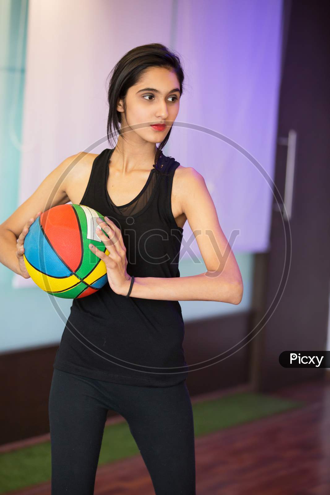 Girl Exercising With A Colorful Ball In Hand, Health And Fitness Concept