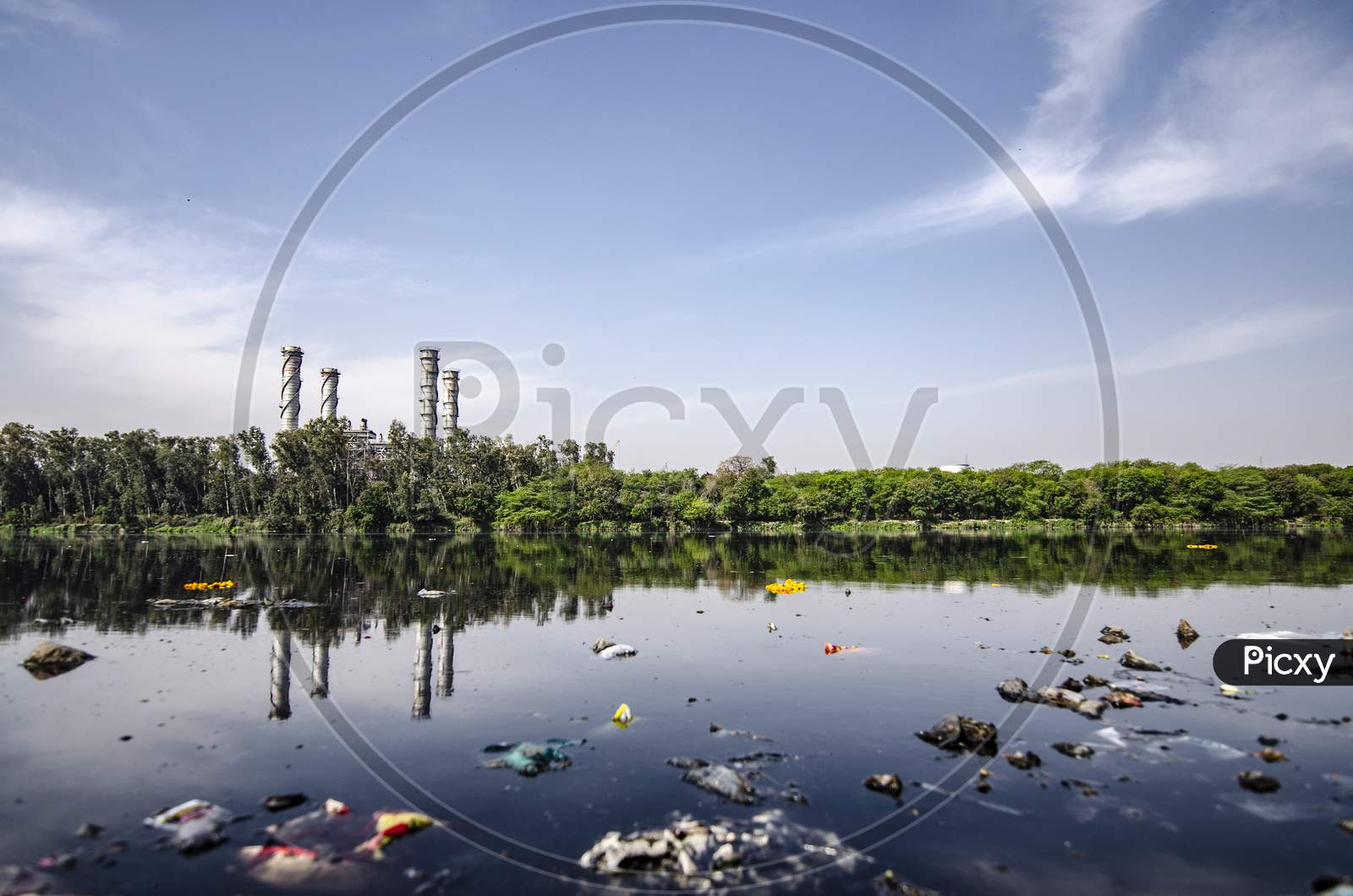Industrial Landscape beside a contaminated river with garbage