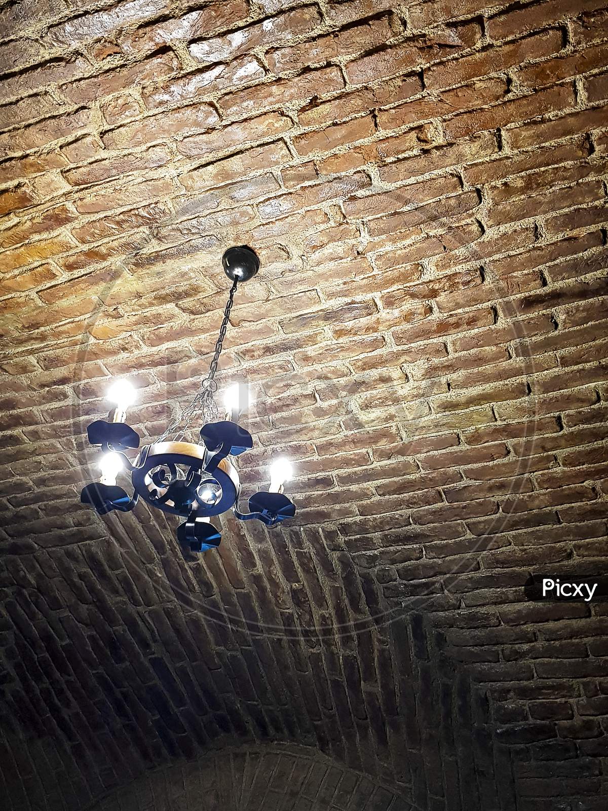 Antique Chandelier Style On Red Brick Ceiling