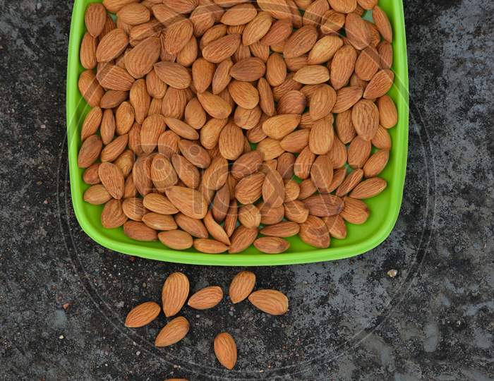 Almonds on a plate. Almonds are healthiest nuts and one of the best brain foods.