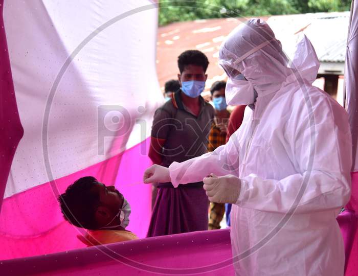 Medics  Collect A Swab Sample Of Migrants Who  Arrived From Chennai Via Shramik Special Train During Nationwide Lockdown Amidst Coronavirus or COVID-19 Pandemic  In Nagaon District Of Assam,India