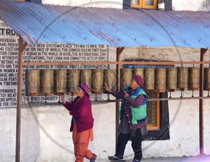 Womens from Himalayan Monastery Touching the Bells
