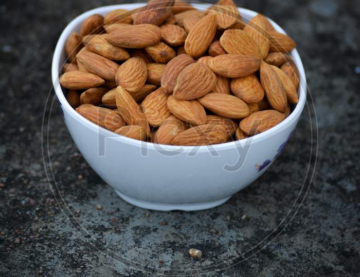 Tasty almond in white bowl