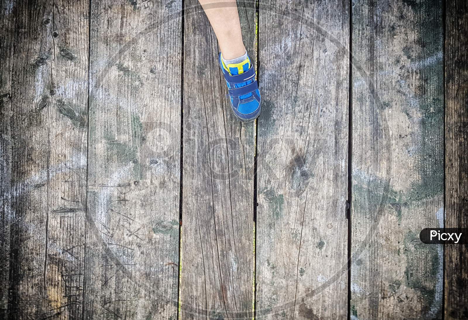 Children'S Foot On Old Plank Floor