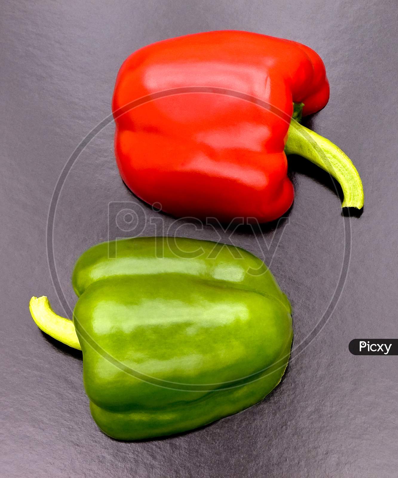 Two cut red & green peppers cut in pattern.