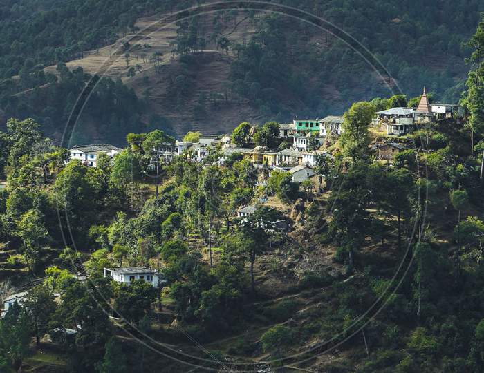 Aerial view of a village situated on the top of the mountain