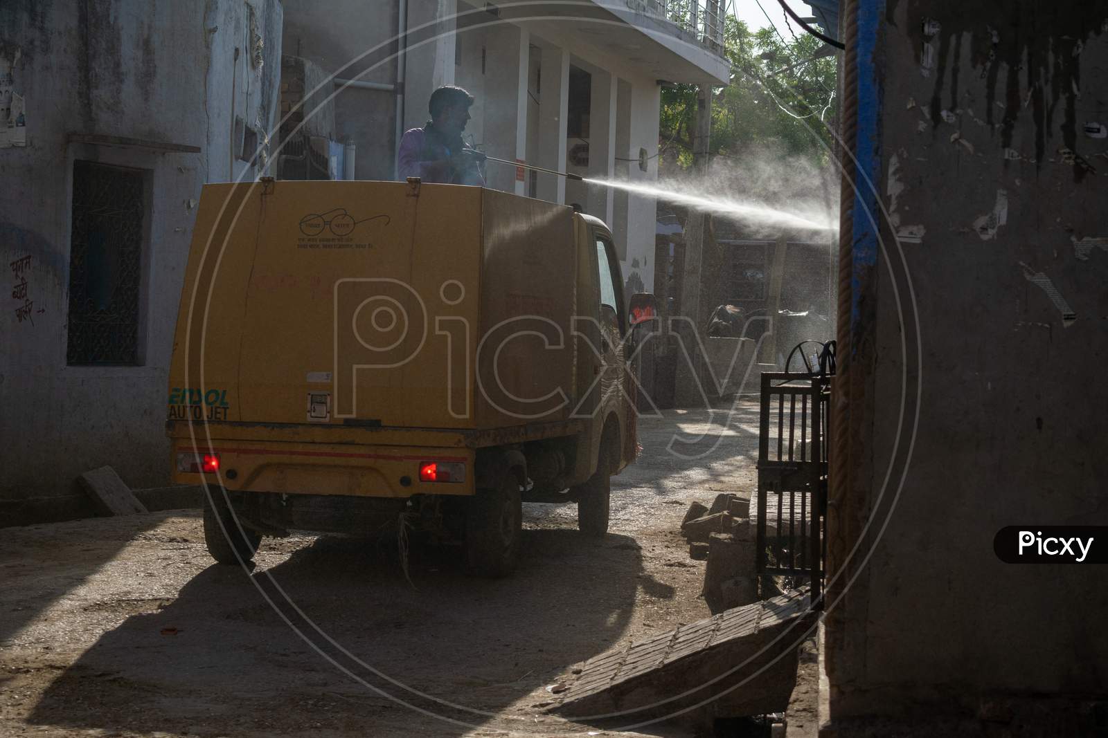 A man on Nagar palika municipality vehicle sprays Disinfectants amid concerns over coronavirus or covid 19