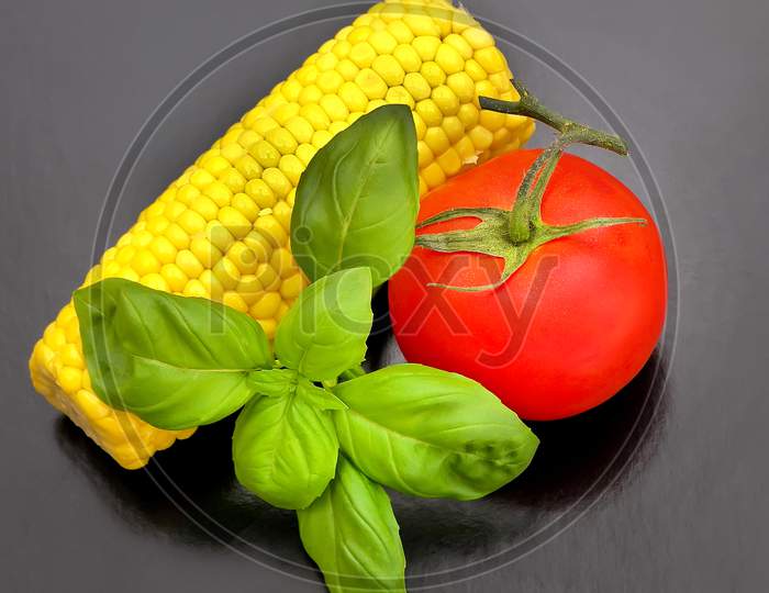 Sweet-corn with tomato and basil.