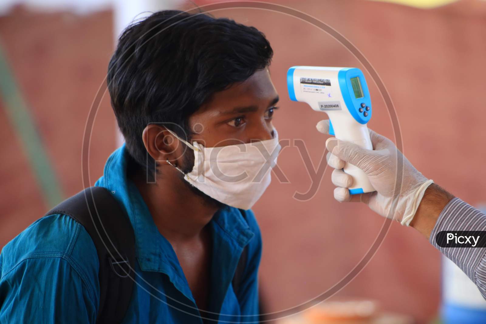 A Health Worker Uses A Thermal Screening Device On A Stranded Pilgrim Before Boarding A Train For Uttar Pradesh At Ajmer Railway Station, During A Government-Imposed Nationwide Lockdown As A Preventive Measure Against The Coronavirus, In Ajmer, Rajasthan, India On  May 17, 2020.