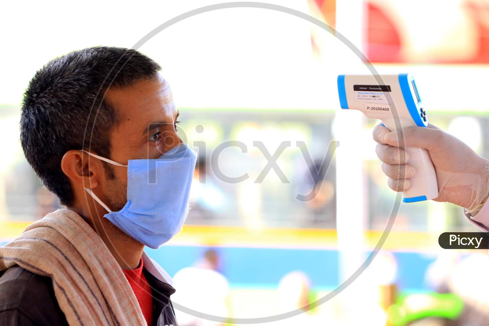 A Health Worker Uses A Thermal Screening Device On A Stranded Pilgrim Before Boarding A Train For Uttar Pradesh At Ajmer Railway Station, During A Government-Imposed Nationwide Lockdown As A Preventive Measure Against The Coronavirus, In Ajmer, Rajasthan, India On  May 17, 2020.