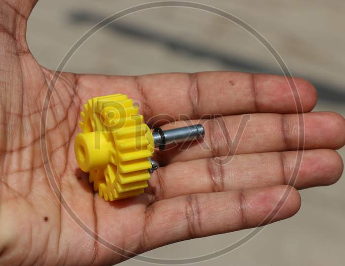 Plastic Gear With Shaft Held In Hand