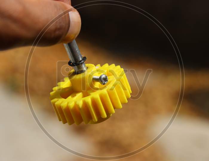 Yellow Plastic Gear Which Can Be Attached To Dc Motor Shaft