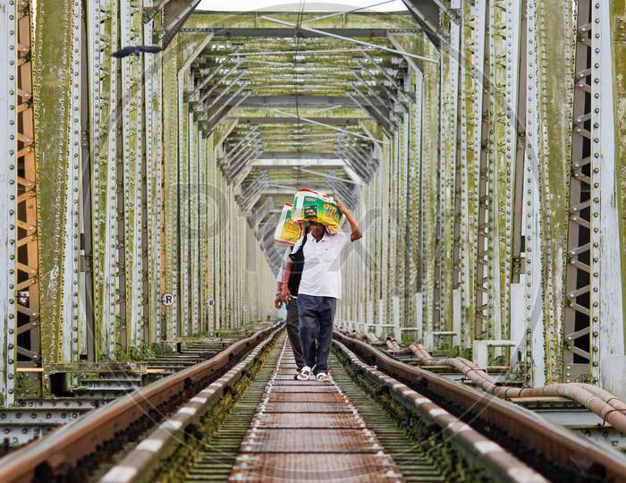 workers walking over railway bridge