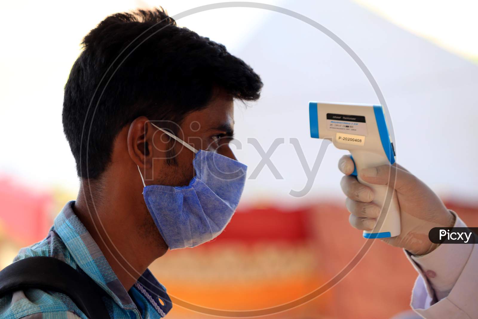 A Health Worker Uses A Thermal Screening Device On A Pilgrim Before He Boards A Train For Uttar Pradesh At Ajmer Railway Station, During A Government-Imposed Nationwide Lockdown As A Preventive Measure Against The Coronavirus, In Ajmer, Rajasthan, India On  May 17, 2020.