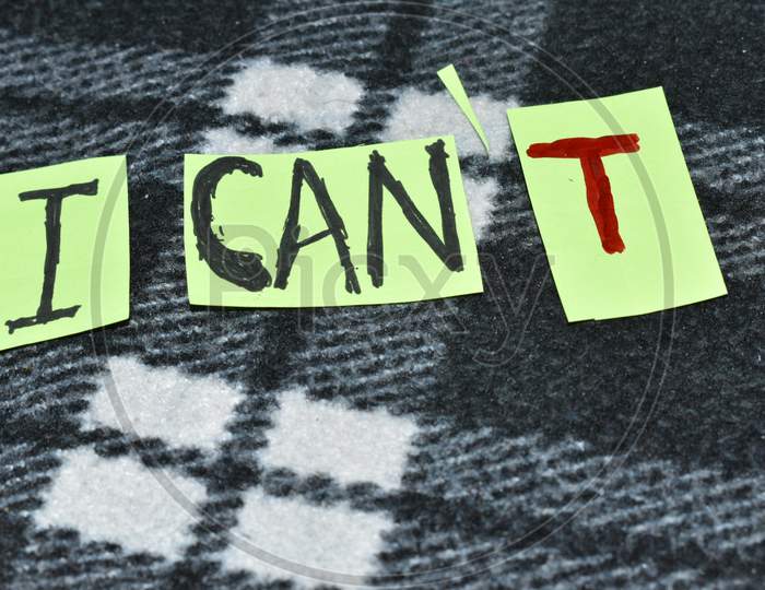 Positive Attitude And Motivation Concept For Self Belief. " I Can" Is Written With Black And Letter 'T' With Red Pen.