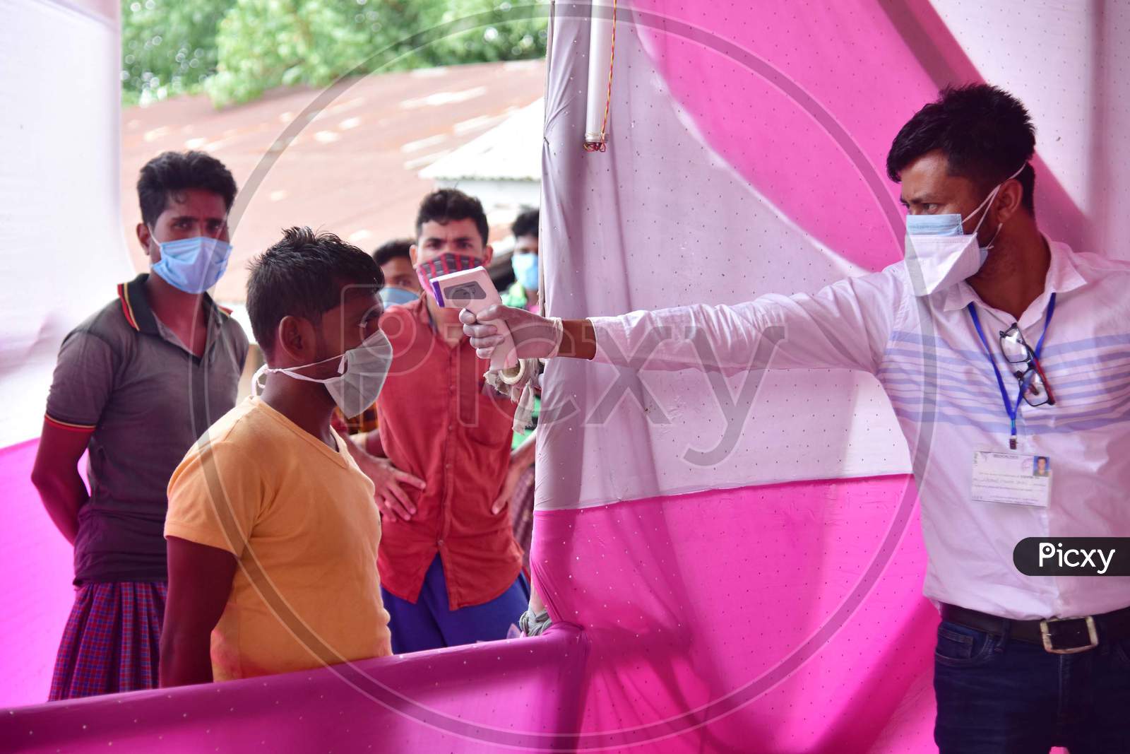 Medics Conduct Thermal Screening  Of Migrants Who  Arrived From Chennai Via Shramik Special Train During Nationwide Lockdown Amidst Coronavirus or COVID-19 Pandemic  In Nagaon District Of Assam,India