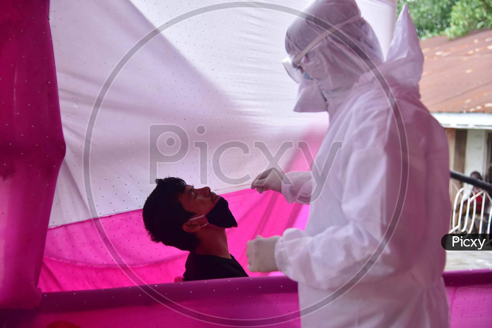 A Medic Collects A Swab Sample Of A Migrant Who Arrived From Chennai Via Shramik Special Train During Nationwide Lockdown Amidst Coronavirus or COVID-19 Pandemic  In Nagaon District Of Assam,India