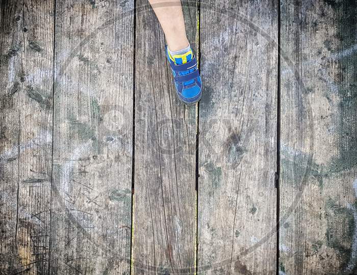 Children'S Foot On Old Plank Floor