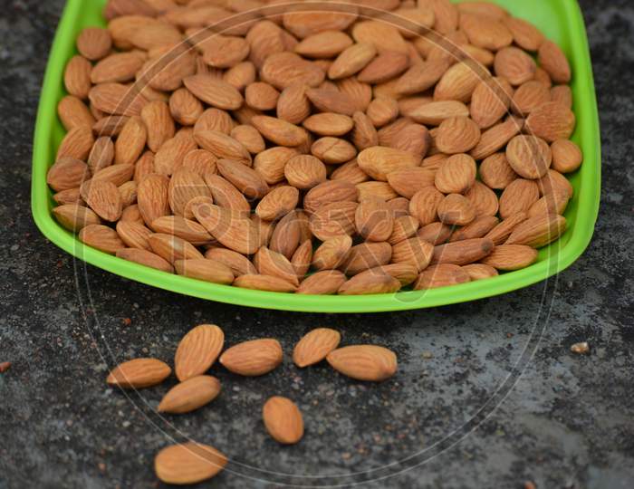 Almonds on a plate. Almonds are healthiest nuts and one of the best brain foods.
