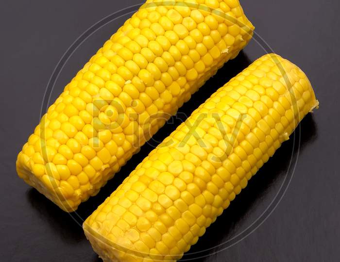 Two sweet corn prepared for cooking.