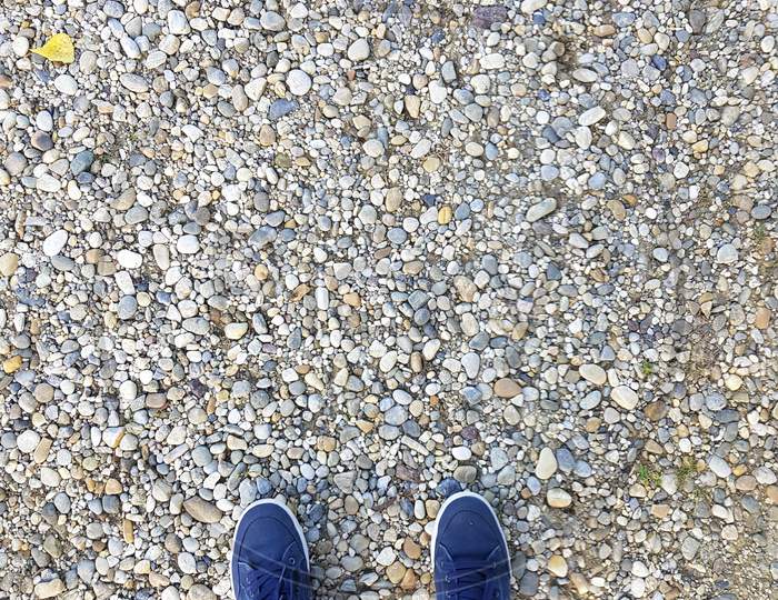 Top View Blue Sneakers On Gravel