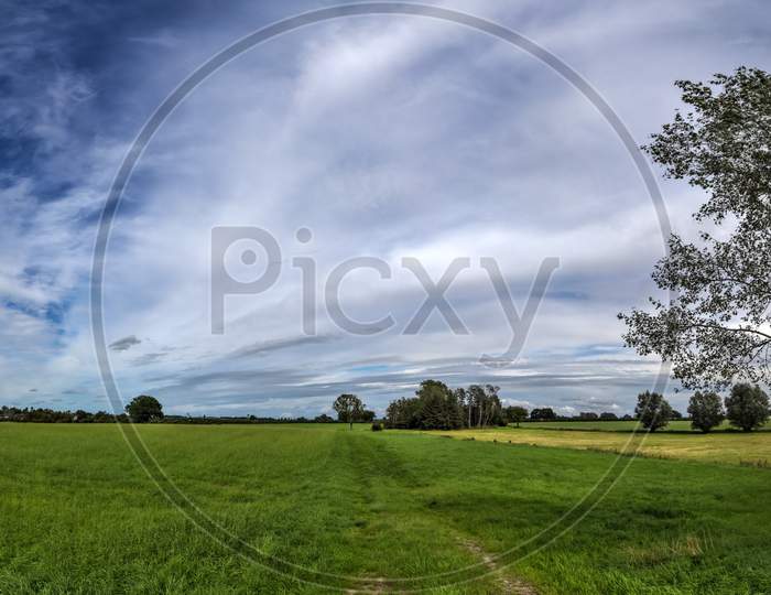 Beautiful panorama of a northern european country landscape with fields and green grass
