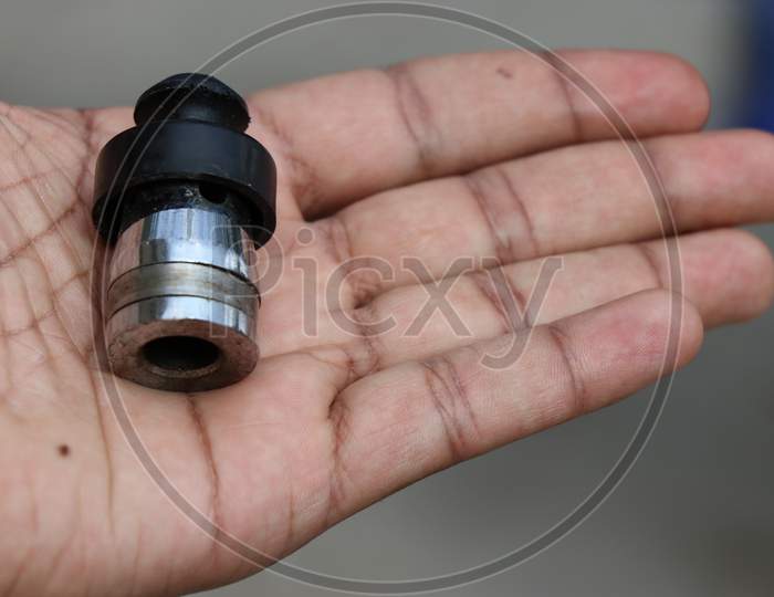 Pressure Cooker Whistle Held In Hand