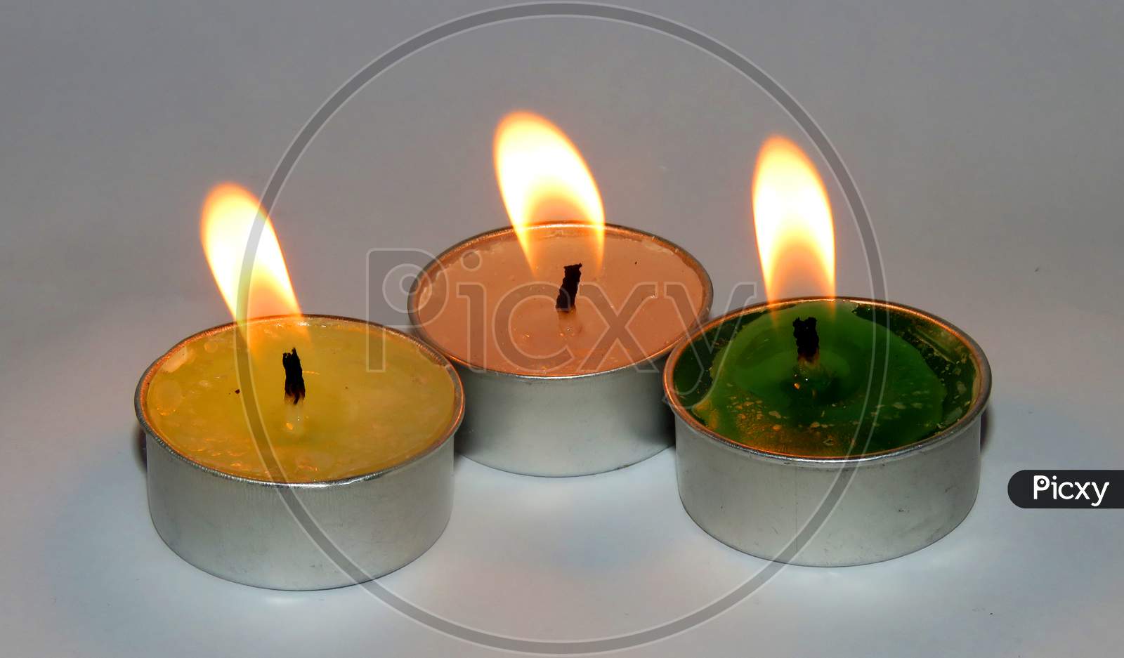 Burning candle on white Background,Isolated Burning Candles.Temple Candles.Burning candle flame,colorful candles