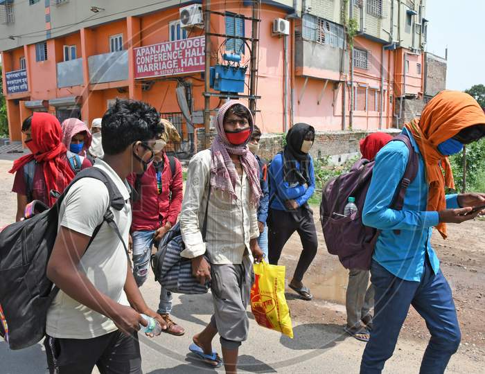 Migrant workers stranded due to lockdown in the emergence of Novel Coronavirus (COVID-19) are walking from Barrackpore (West Bengal) to Bihar on their own initiative. Migrant workers are walking on the 2 no National Highway towards their destination. At Burdwan Town.