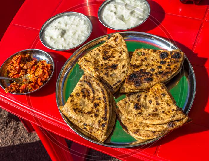 Tasty Indian breakfast, Parathas with curd and tea, Indian Breakfast