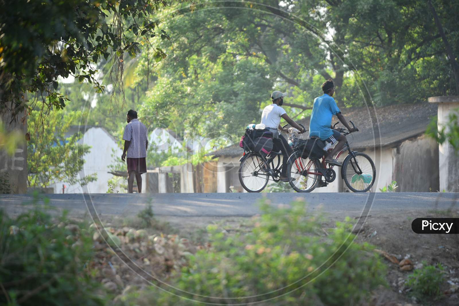 Migrant Workers seen cycling at Telangana State Border in Aswaraopet in a bid to reach their hometowns in West Bengal and Bihar