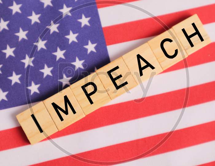 Concept Of Us Politics, Impeachment Showing With Us Flag With Impeach In Wooden Letters.