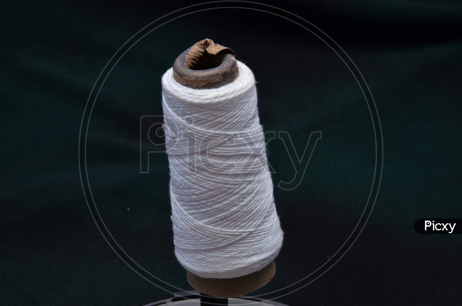 White Thread Roll with Black Background View