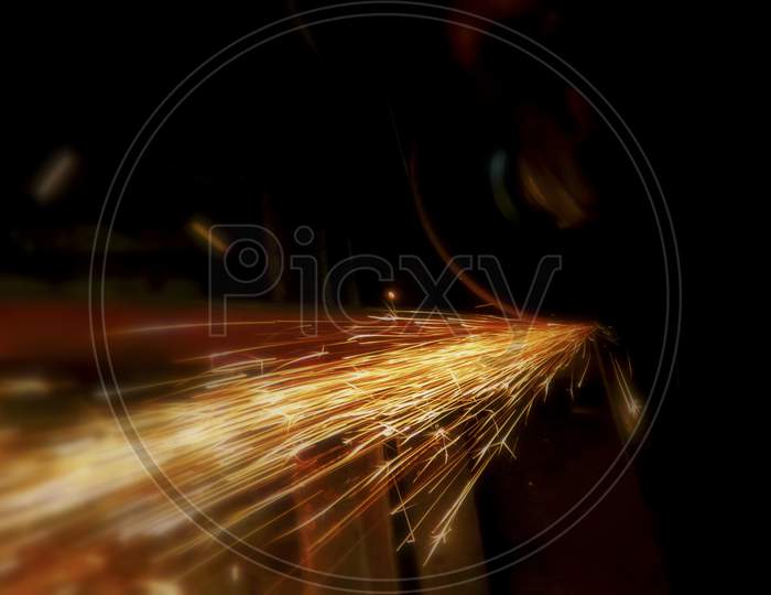 Fire Sparks On A Black Background During Metal Cutting, Hot Burning Element In Flame.Selective Focus.