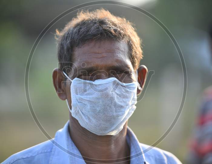 Migrant workers from West Bengal and Bihar waits for permission to cross Telangana State at a Checkpost in Aswaropeta during an extended lockdown amid coronavirus fears, May 16,2020.