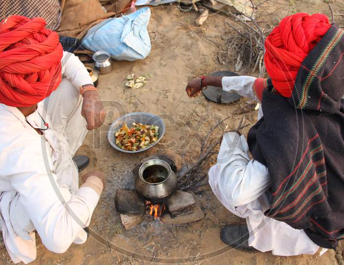 Camel Traders Cooking Food As a Group In Pushkar Camel Fair, Pushkar