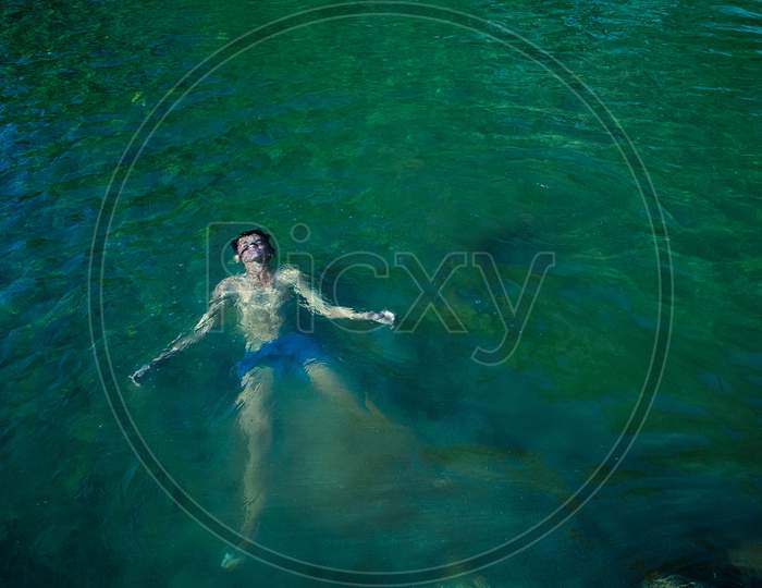 Nerwa Village, Himachal Pradesh, India - July 20Th, 2019: Young Boy Swimming In The Fresh River Water. Summer Vacation Concept