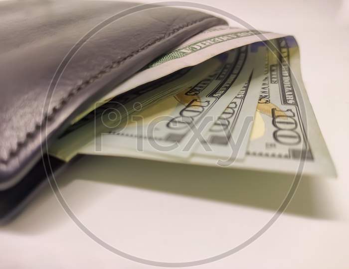 Black Wallet Full Of 100 Dollar Bills.