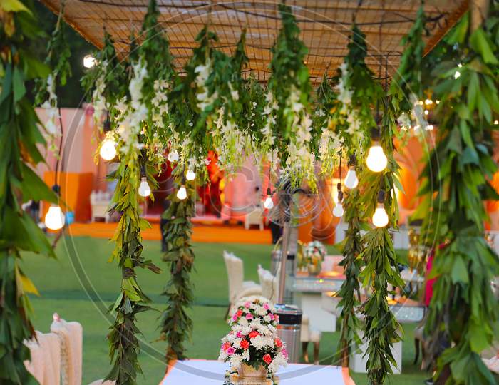 Luxurious Dinner Tables With Hanging Lights, Decoration With Flowers Wedding Background - Image