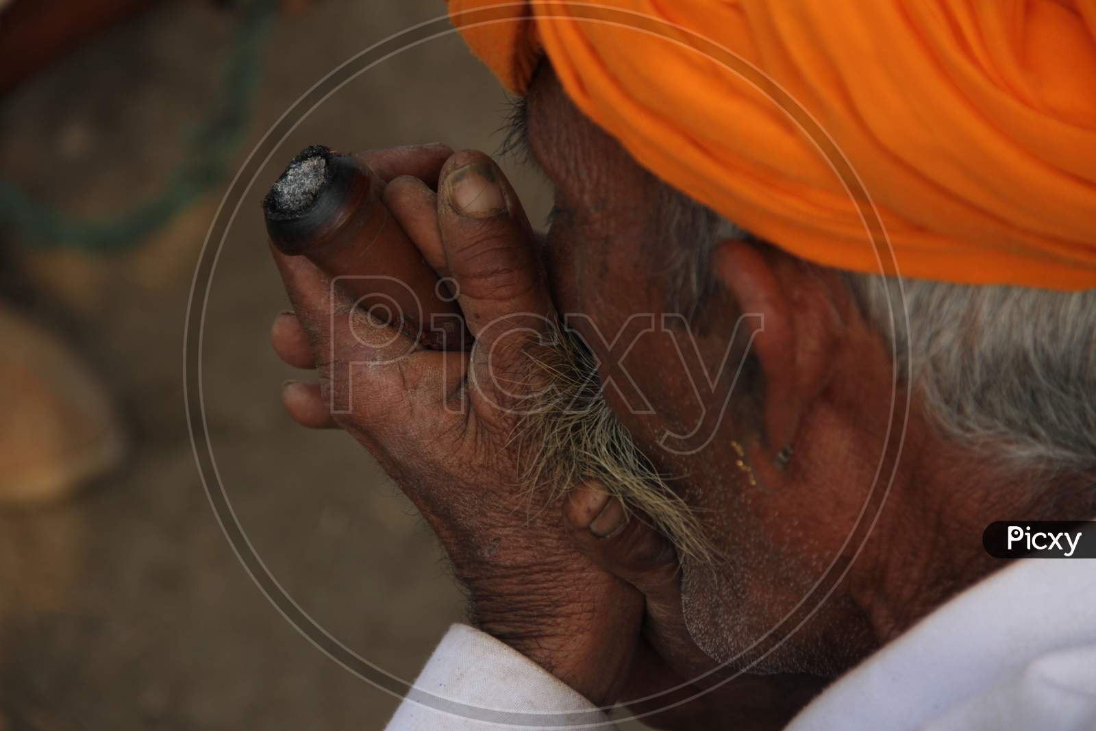 A Camel Traders Smoking Weed or Ganja  at Pushkar Camel Fair, pushkar